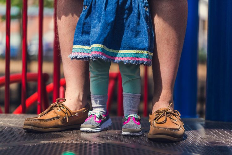 dad-and-daughter-legs-in-playground